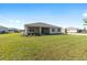 An inviting backyard features a screened lanai and ample green space for outdoor activities at 10569 Sw 98Th Pl, Ocala, FL 34481