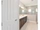 Modern bathroom featuring double sinks, sleek vanity, and a glass-enclosed shower, offering a spa-like experience at 10569 Sw 98Th Pl, Ocala, FL 34481