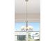 Dining room featuring a chandelier and a large window, offering plenty of light and suburban views at 10569 Sw 98Th Pl, Ocala, FL 34481
