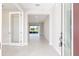 Bright and airy foyer with tile flooring, transom window, and view of the living room at 10569 Sw 98Th Pl, Ocala, FL 34481