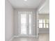 Bright foyer with a decorative glass front door and a view into a room with a large window at 10569 Sw 98Th Pl, Ocala, FL 34481
