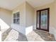 Close up of front entrance featuring brick pavers, decorative columns, and an elegant front door at 10569 Sw 98Th Pl, Ocala, FL 34481