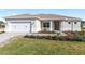 Charming single-story home features landscaped lawn, paver driveway, and inviting front entrance at 10569 Sw 98Th Pl, Ocala, FL 34481