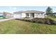 Single-story home boasts a manicured lawn, a paver driveway, and a delightful front entrance at 10569 Sw 98Th Pl, Ocala, FL 34481