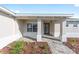 Inviting front porch with decorative columns, elegant brick pavers, and attractive landscaping at 10569 Sw 98Th Pl, Ocala, FL 34481
