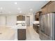 Spacious kitchen with a center island, stainless steel appliances, and modern cabinets, perfect for cooking and dining at 10569 Sw 98Th Pl, Ocala, FL 34481