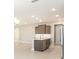 Open kitchen with an island, stainless steel appliances, and modern cabinetry for cooking and entertaining at 10569 Sw 98Th Pl, Ocala, FL 34481