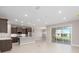 Open-concept living area with tile floors, recessed lighting, and sliding glass doors to the patio at 10569 Sw 98Th Pl, Ocala, FL 34481