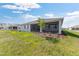 A well maintained backyard features a screened lanai and lush green lawn at 10976 Sw 101St Loop, Ocala, FL 34481