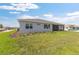 This backyard features a screened in patio, lush green grass, and landscaping at 10976 Sw 101St Loop, Ocala, FL 34481