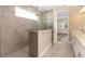 Modern bathroom with tiled shower, glass partition, and light gray vanity at 10976 Sw 101St Loop, Ocala, FL 34481