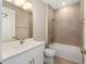 This bathroom features a white vanity, framed mirror, shower and bathtub at 10976 Sw 101St Loop, Ocala, FL 34481