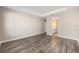 Bedroom showcasing hardwood floors and en-suite bathroom at 10976 Sw 101St Loop, Ocala, FL 34481