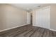 This bedroom features wood-look flooring and a closet with white doors at 10976 Sw 101St Loop, Ocala, FL 34481