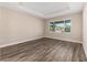 Bright bedroom with hardwood floors and large window at 10976 Sw 101St Loop, Ocala, FL 34481