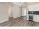 Elegant butler pantry with white cabinetry, a beverage cooler, and wood-look flooring near the front entrance at 10976 Sw 101St Loop, Ocala, FL 34481