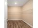 Walk-in closet with installed shelving and hardwood floors at 10976 Sw 101St Loop, Ocala, FL 34481