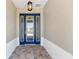 Elegant front door with decorative glass panels and neutral surroundings, complemented by a paved walkway at 10976 Sw 101St Loop, Ocala, FL 34481
