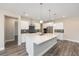 Bright kitchen featuring white cabinetry, stainless steel appliances, and a large island with pendant lighting at 10976 Sw 101St Loop, Ocala, FL 34481