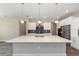 Spacious kitchen with a large center island, stainless steel appliances, and modern pendant lighting at 10976 Sw 101St Loop, Ocala, FL 34481