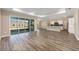 Bright living room featuring wood flooring, recessed lighting, and sliding doors to a screened patio at 10976 Sw 101St Loop, Ocala, FL 34481