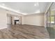 Open-concept living area features recessed lighting, a tray ceiling, wood flooring, and sliding glass doors at 10976 Sw 101St Loop, Ocala, FL 34481
