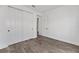 Bright bedroom with hardwood flooring and closet with white sliding doors at 10977 Sw 101St Loop, Ocala, FL 34481