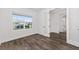 Bright bedroom with dark hardwood flooring and large window at 10977 Sw 101St Loop, Ocala, FL 34481