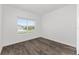 Bright bedroom featuring large window, hard surface flooring, and ample light at 10977 Sw 101St Loop, Ocala, FL 34481
