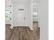 Spacious foyer with wood-look floors, offering a view into the home's interior at 10977 Sw 101St Loop, Ocala, FL 34481