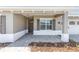 Covered front porch with a brick paver walkway, offering a welcoming entrance to the home at 10977 Sw 101St Loop, Ocala, FL 34481