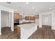 Well-lit kitchen with a large center island, stainless steel appliances, and lots of cabinet storage at 10977 Sw 101St Loop, Ocala, FL 34481