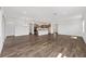 Open-concept floor plan showcasing wood-look floors, kitchen, and adjoining rooms at 10977 Sw 101St Loop, Ocala, FL 34481