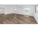 Bright and airy living room showcasing wood-look floors and an entrance to the front door at 10977 Sw 101St Loop, Ocala, FL 34481