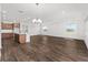 Spacious area featuring wood-look floors and flowing seamlessly to the kitchen with island and dining at 10977 Sw 101St Loop, Ocala, FL 34481