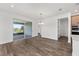 Bright dining area with sliding glass doors to the patio, chandelier, and open to the kitchen area at 10977 Sw 101St Loop, Ocala, FL 34481