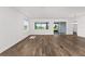 Bright living room with wood-look floors and large windows offering natural light at 10977 Sw 101St Loop, Ocala, FL 34481
