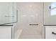 Luxurious glass shower with marble-style tiling and a built-in bench at 10977 Sw 101St Loop, Ocala, FL 34481