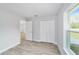 Bedroom featuring neutral paint, base molding, new flooring, and natural light at 13316 Sw 105Th Pl, Dunnellon, FL 34432