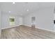 Bright living room features neutral paint, modern recessed lighting and wood-look flooring at 13316 Sw 105Th Pl, Dunnellon, FL 34432