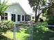 Serene backyard with lanai, a large shade tree, and a fenced perimeter, offering a quiet outdoor space at 13762 Sw 112Th Ter, Dunnellon, FL 34432