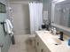 Cozy bathroom with tub and shower with curtain, marble-topped vanity with sink, and framed mirror at 13762 Sw 112Th Ter, Dunnellon, FL 34432