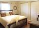 Comfortable bedroom with a wooden frame bed, wreath wall decor, and double closets at 13762 Sw 112Th Ter, Dunnellon, FL 34432