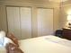 Bedroom with white bedding and pillows, light walls, and double bi-fold door closets at 13762 Sw 112Th Ter, Dunnellon, FL 34432