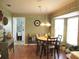 Cozy dining area with a round table, chandelier, and bay windows for ample natural light at 13762 Sw 112Th Ter, Dunnellon, FL 34432