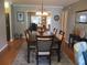 This dining room features a chandelier, wood table, and seating for six people with room to entertain at 13762 Sw 112Th Ter, Dunnellon, FL 34432