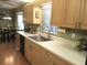 Bright eat-in kitchen with wooden cabinets, modern appliances, and view of the breakfast nook seating area at 13762 Sw 112Th Ter, Dunnellon, FL 34432
