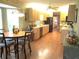 Open concept kitchen with light wood cabinets, black appliances, and breakfast nook at 13762 Sw 112Th Ter, Dunnellon, FL 34432