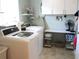 Well-equipped laundry room with modern washer, dryer, built-in cabinets, and counter space at 13762 Sw 112Th Ter, Dunnellon, FL 34432