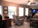 Bright living area featuring natural light, tile flooring, and comfortable seating arrangement at 13762 Sw 112Th Ter, Dunnellon, FL 34432